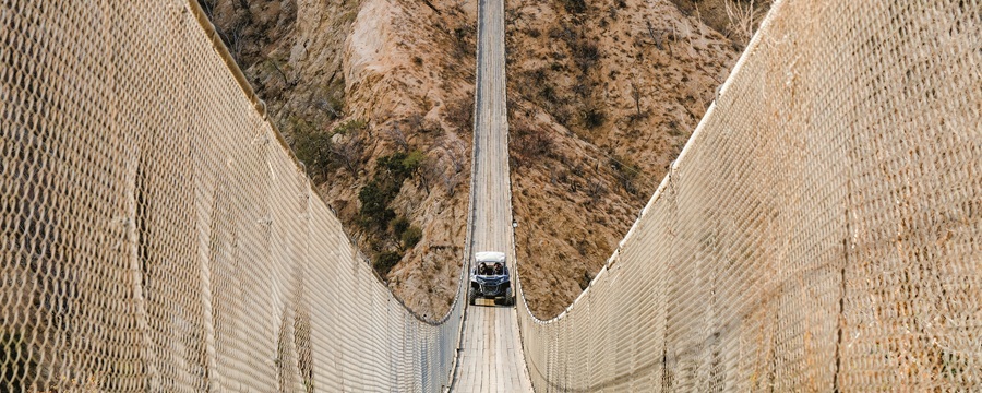 Tourists ziplining over scenic desert canyons in Los Cabos